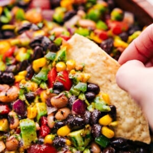 Cowboy Caviar in a bowl with a chip dipping in.