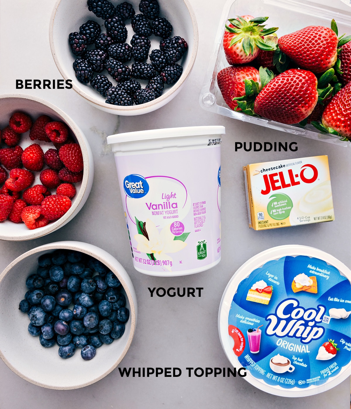 Ingredients In Cheesecake Fruit Salad All the ingredients in this recipe prepped out for easy assembly including the berries, vanilla, jell-o, and cool whip.