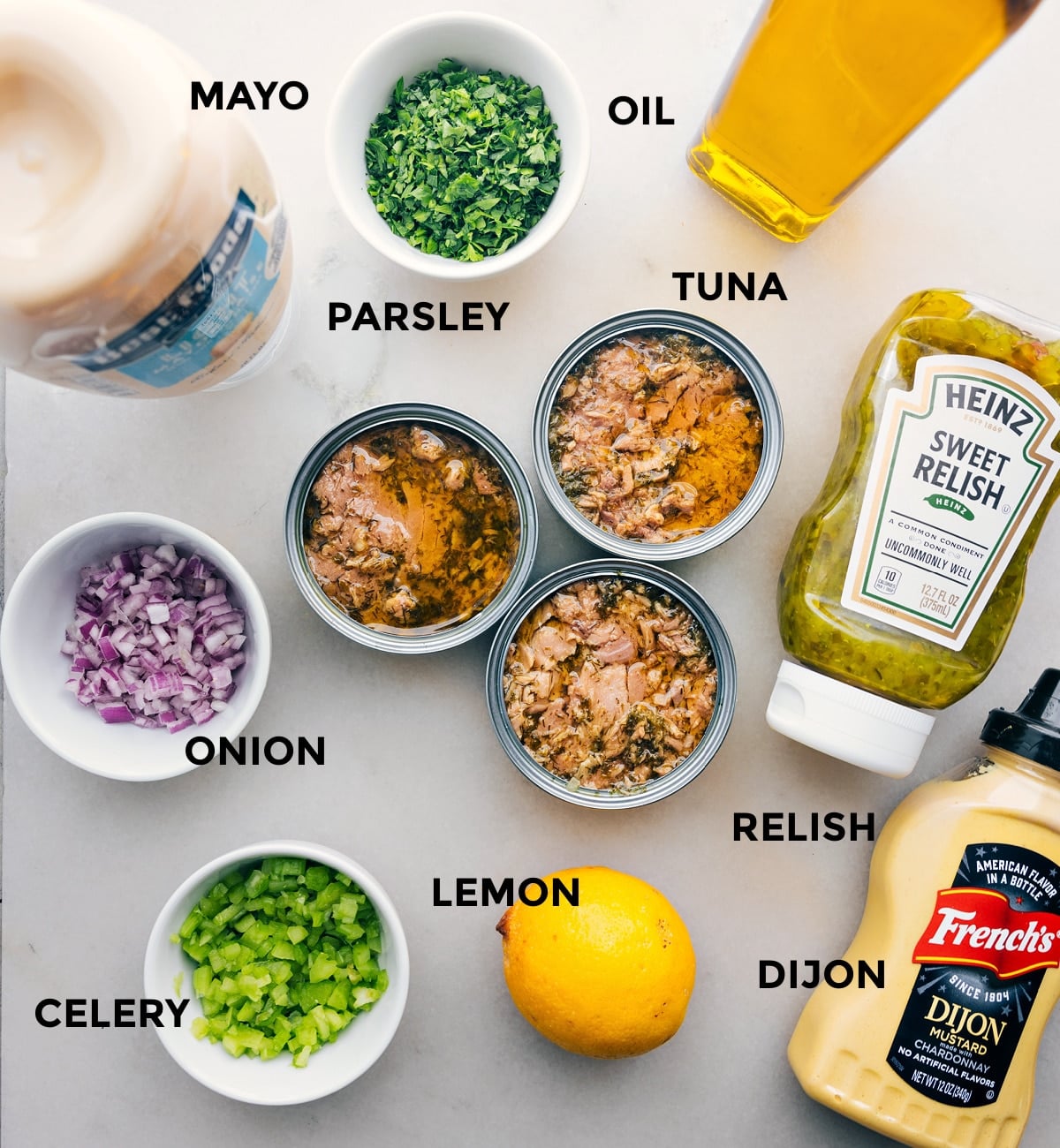 Ingredients Assembled All the ingredients laid out, including mayo, parsley, oil, tuna, onion, relish, lemon, dijon, and celery.