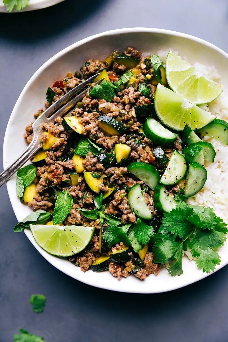 Beef Larb with Rice, Garnished with Lime and Cilantro Beef larb accompanied by rice, with lime and cilantro garnishes.