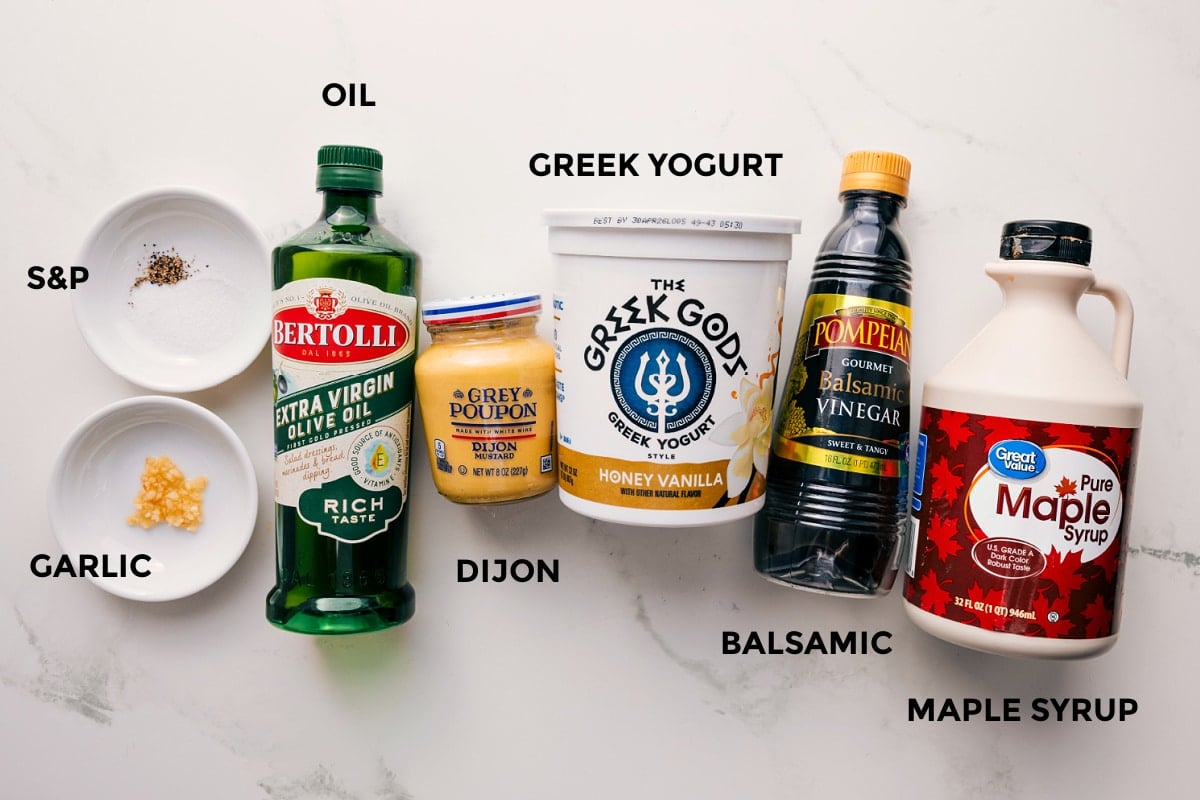 Ingredients In Creamy Balsamic Dressing Recipe All the ingredients in this recipe prepped out for easy assembly including the garlic, oil, dijon, greek yogurt, balsamic, and maple syrup.