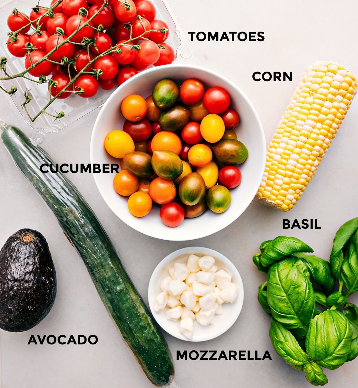 Ingredients In Panzanella All the ingredients for this recipe are prepped for easy assembly, including the tomatoes, corn, cucumber, basil, mozzarella, and avocado.