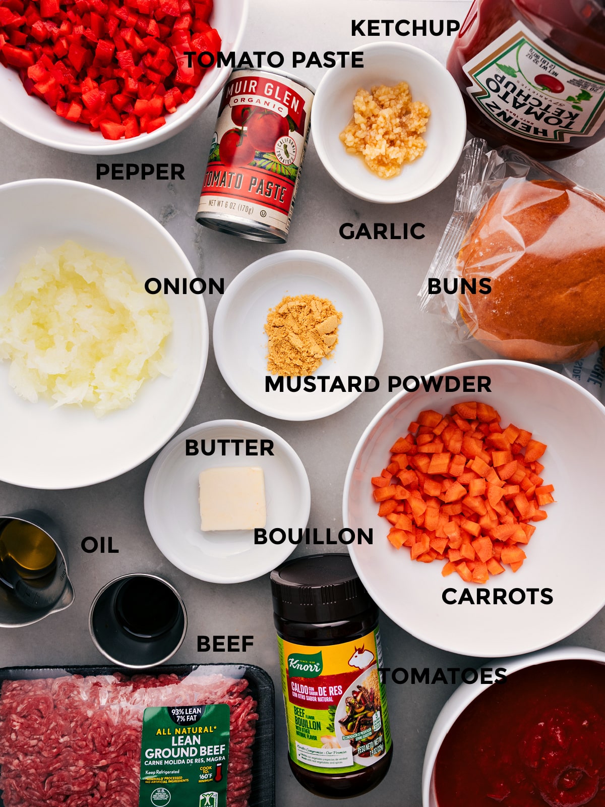 Preparing Sloppy Joe: From Veggies to Beef to Seasoning All the ingredients for this recipe—ketchup, pepper, tomato paste, buns, seasonings, onion, butter, bouillon, beef, and tomatoes—prepped and ready for easy assembly.