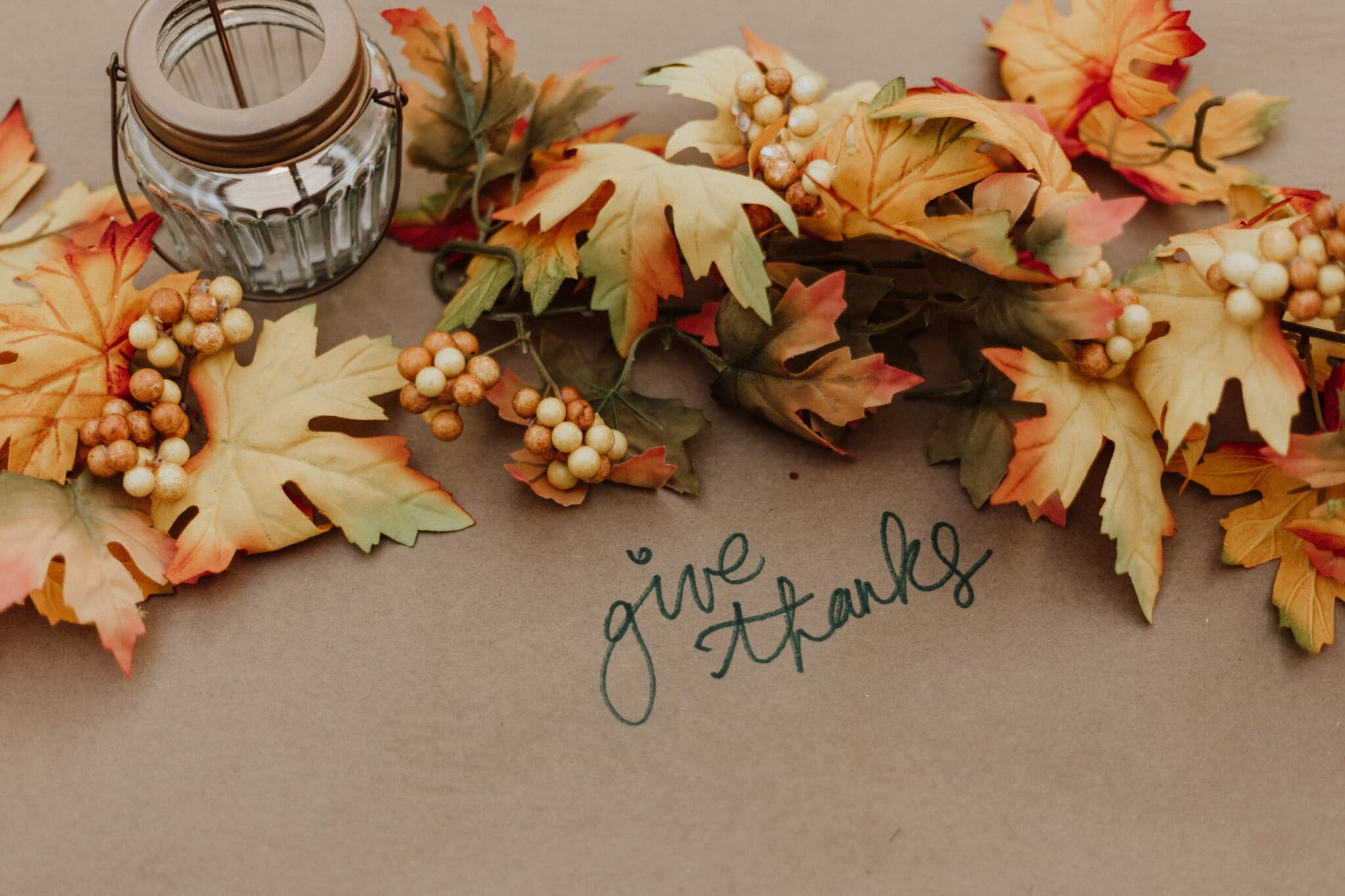 Gorgeous Thanksgiving Table Decor A collection of fall foliage with the message saying "give thanks."