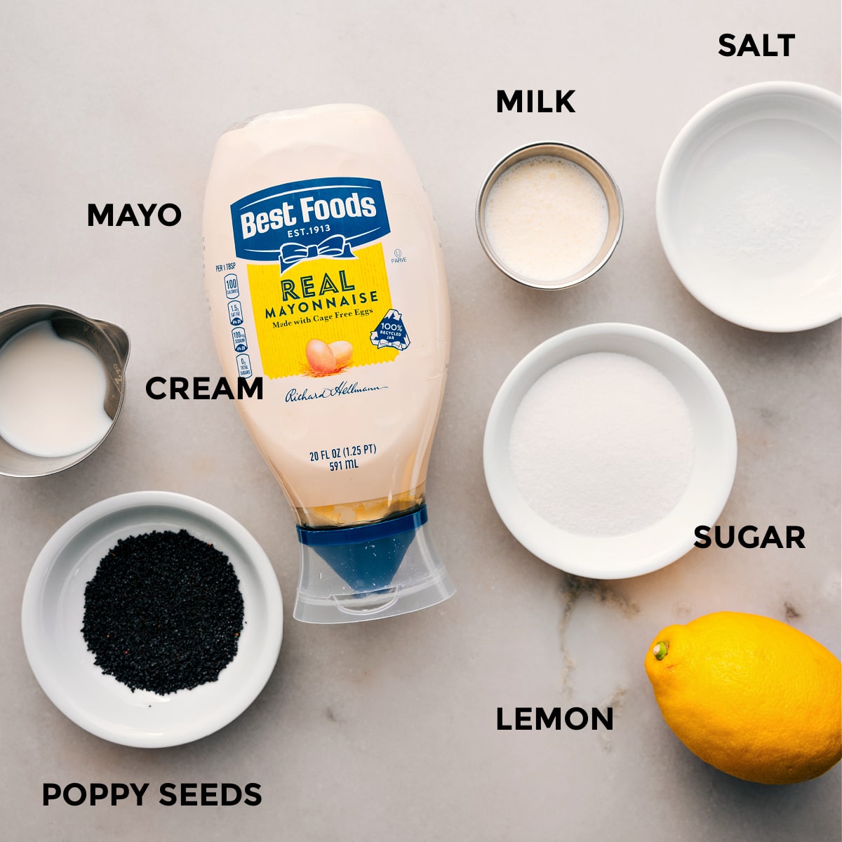 The Best Poppyseed Dressing For This Blackberry Salad The dressing ingredients for this blackberry salad are prepped for easy assembly, including mayo, cream, sugar, lemon, milk, salt, and poppyseeds.