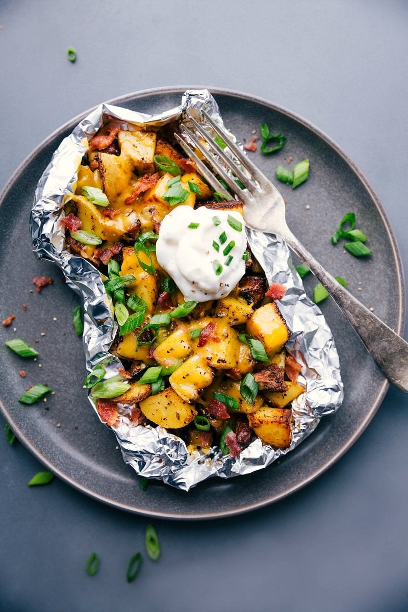 Hearty Baked Potato Foil Pack: Topped with Sour Cream and Chives Baked potato foil pack with sour cream and chives, a hearty meal ready to enjoy.