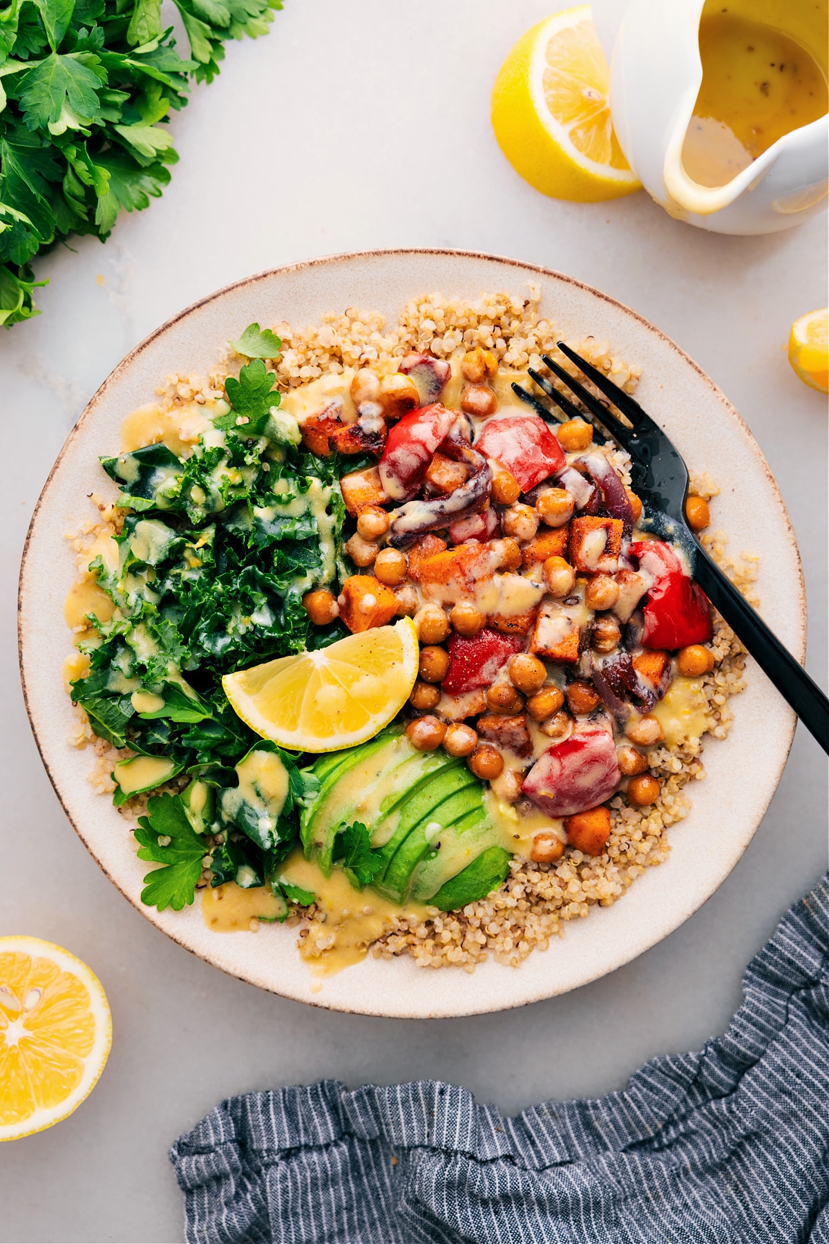 Buddha Bowl with quinoa as the base, topped with delicious dressing and ready to enjoy.