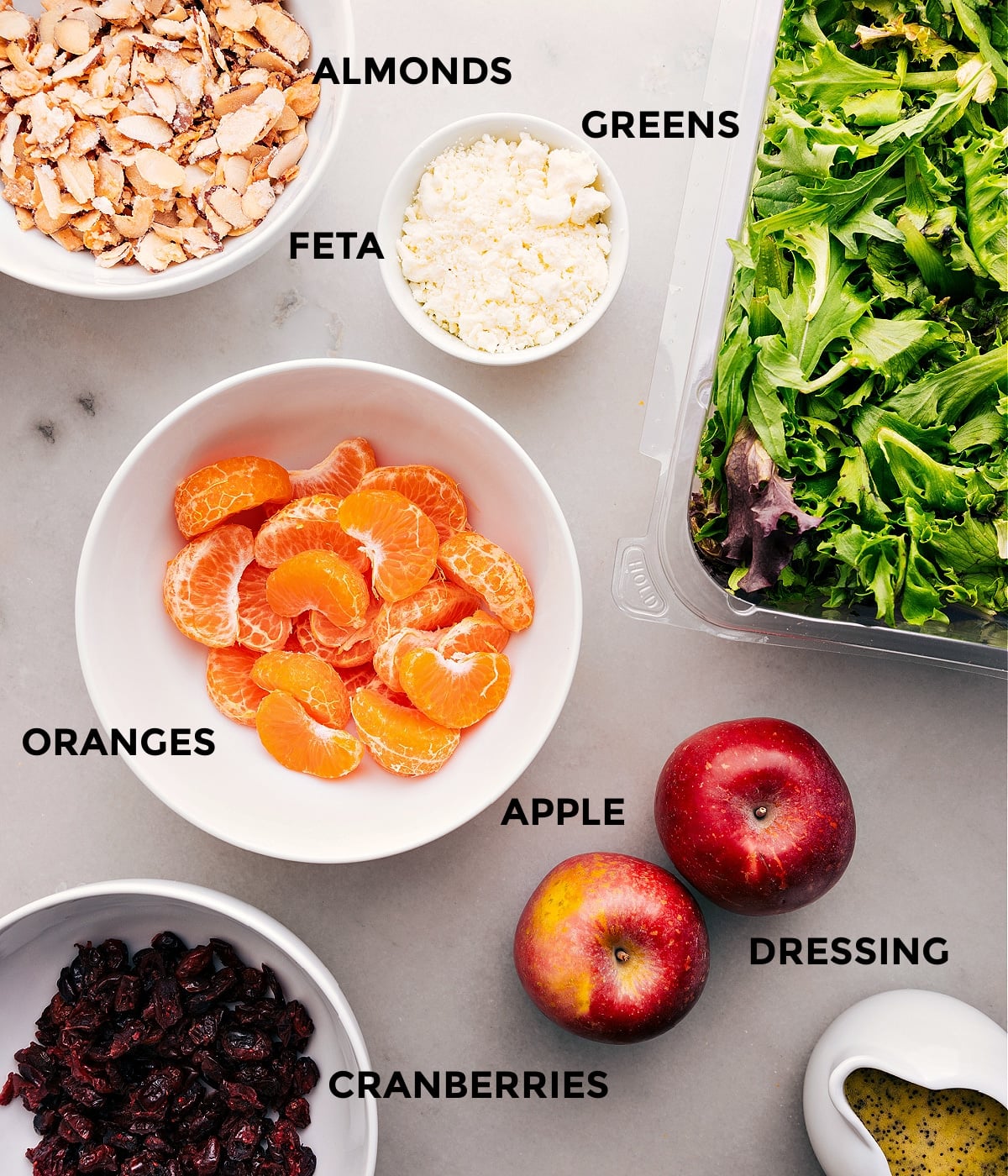 Ingredients In Mandarin Orange Salad Recipe Prep all the ingredients for this recipe, including almonds, greens, fruit, feta, dressing, and dried cranberries, for easy assembly.