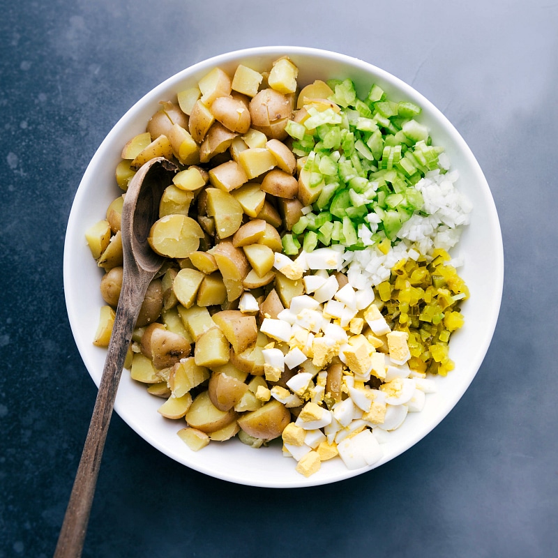 Diced celery, onion, hard-boiled eggs, and pickles prepared as additional ingredients.