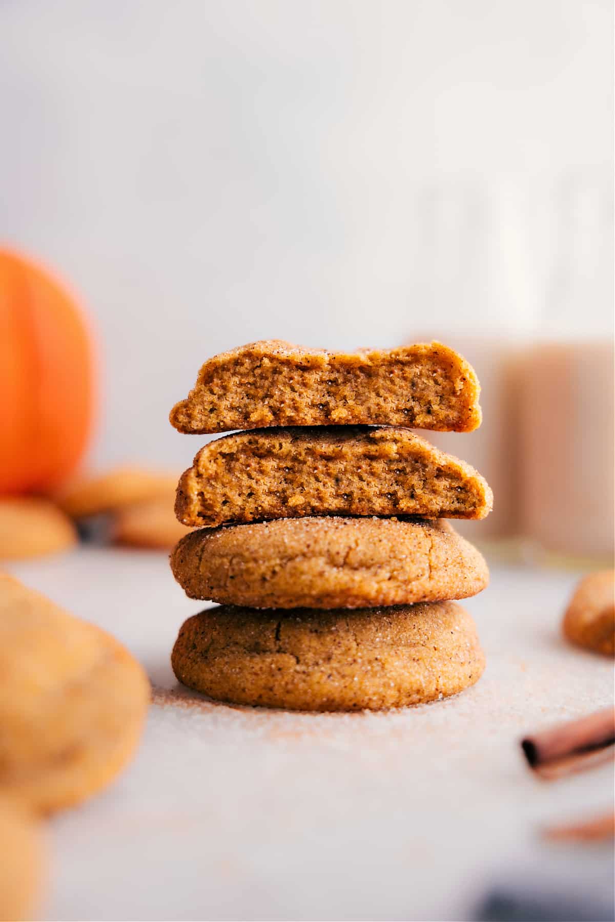 Pumpkin Snickerdoodles with Soft Center Revealed Stack of pumpkin snickerdoodles with one cookie split open, revealing the soft, moist center.