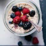 Berry overnight oats, healthy and ready for on-the-go consumption, topped with an assortment of fresh berries.