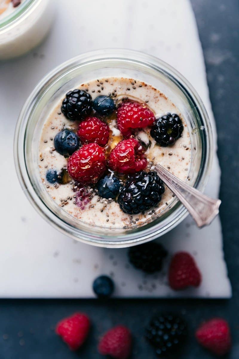 Ready-to-Eat Berry Overnight Oats with Fresh Fruit Topping - Perfect for On-the-Go Berry overnight oats, healthy and ready for on-the-go consumption, topped with an assortment of fresh berries.
