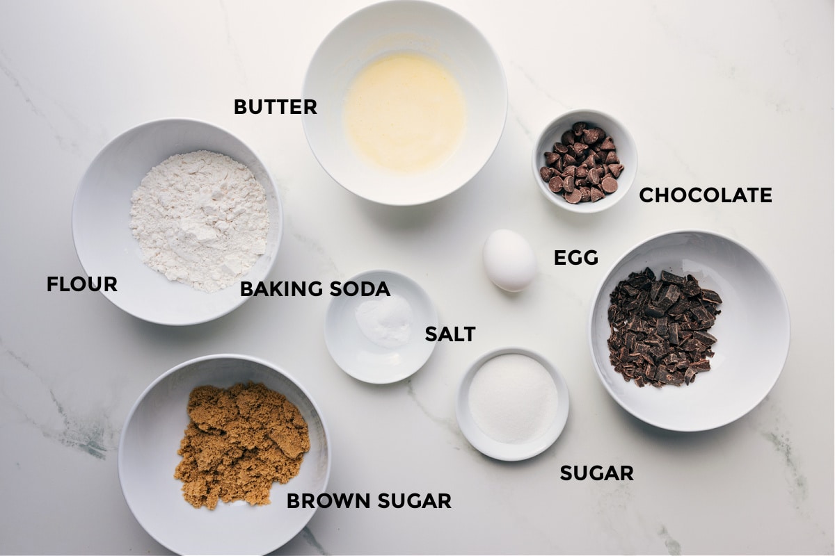 Ingredients In Small Batch Chocolate Chip Cookies Ingredients prepped for easy assembly, including butter, flour, baking soda, chocolate, egg, sugar, and brown sugar.