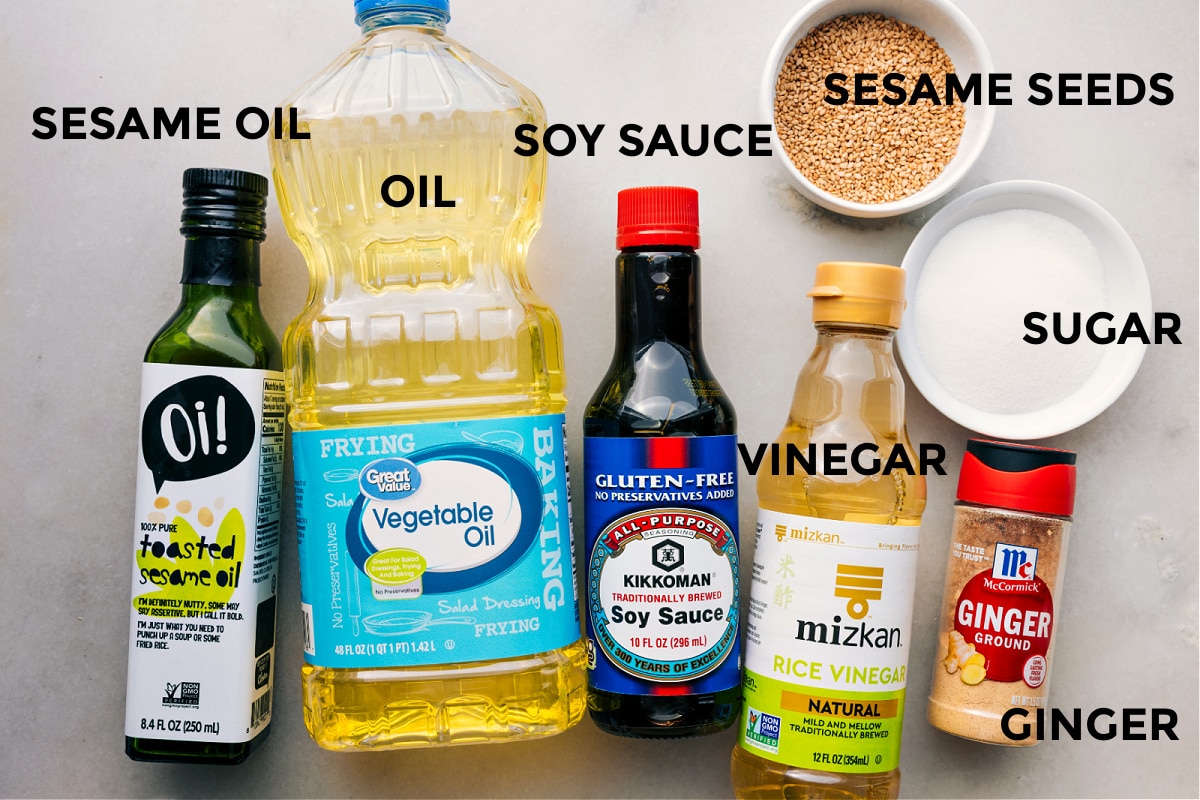 Dressing Ingredients In Asian Pasta Salad Dressing ingredients prepped and ready: sesame oil, vegetable oil, soy sauce, vinegar, sesame seeds, sugar, and ginger.