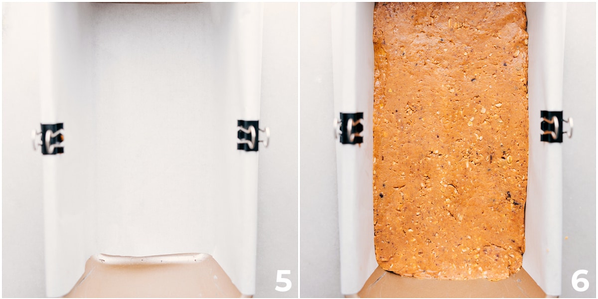 Making Homemade Protein Bars The recipe being pressed into a pan lined with parchment paper.