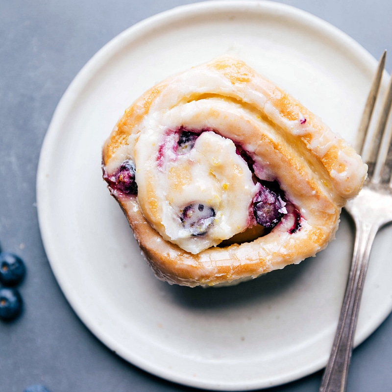 Delicious Lemon Blueberry Sweet Roll on a Plate, Ready to Savor Lemon blueberry sweet roll on a plate, ready to be enjoyed.