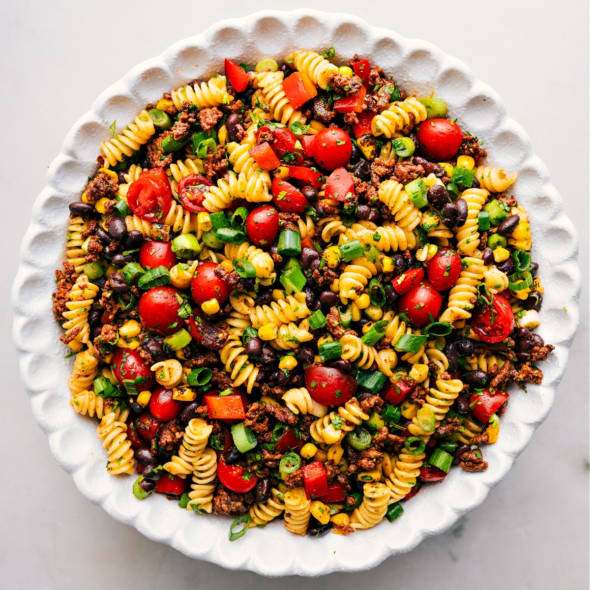 The Perfect Dish To Bring To Your Next BBQ: Taco Pasta Salad The dish is in a bowl, tossed together and ready for the creamy dressing.