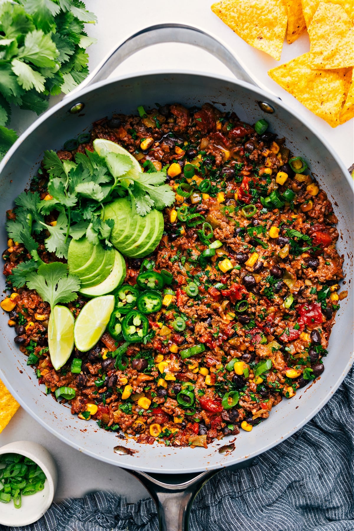 The Best Taco Skillet Recipe Taco Skillet in the pot, topped with avocado, cilantro, lime, and jalapeรฑo, ready to enjoy.