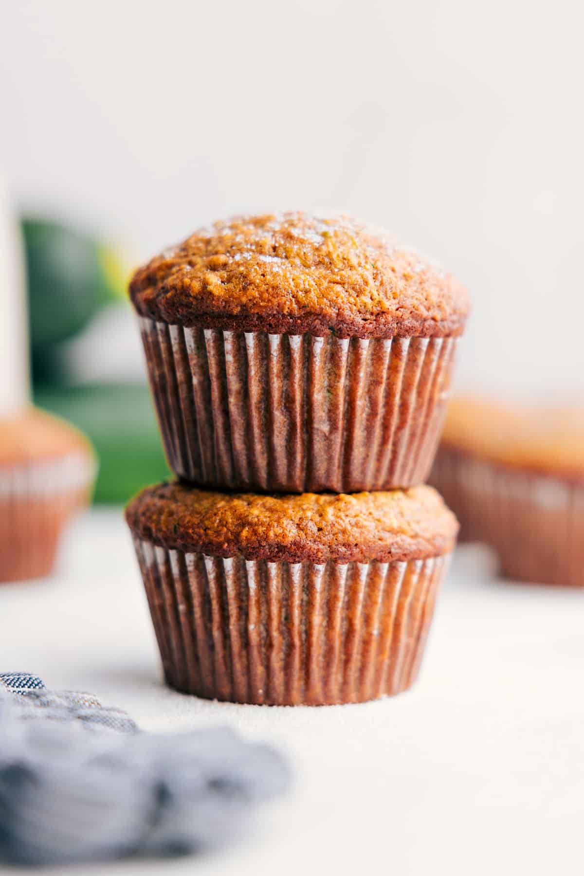Freshly baked Banana Zucchini Muffins stacked on top of each other, ready to enjoy.
