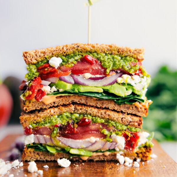 Easy, vegetarian Mediterranean Sandwichโpile veggies, creamy feta cheese, and basil pesto on hearty bread.