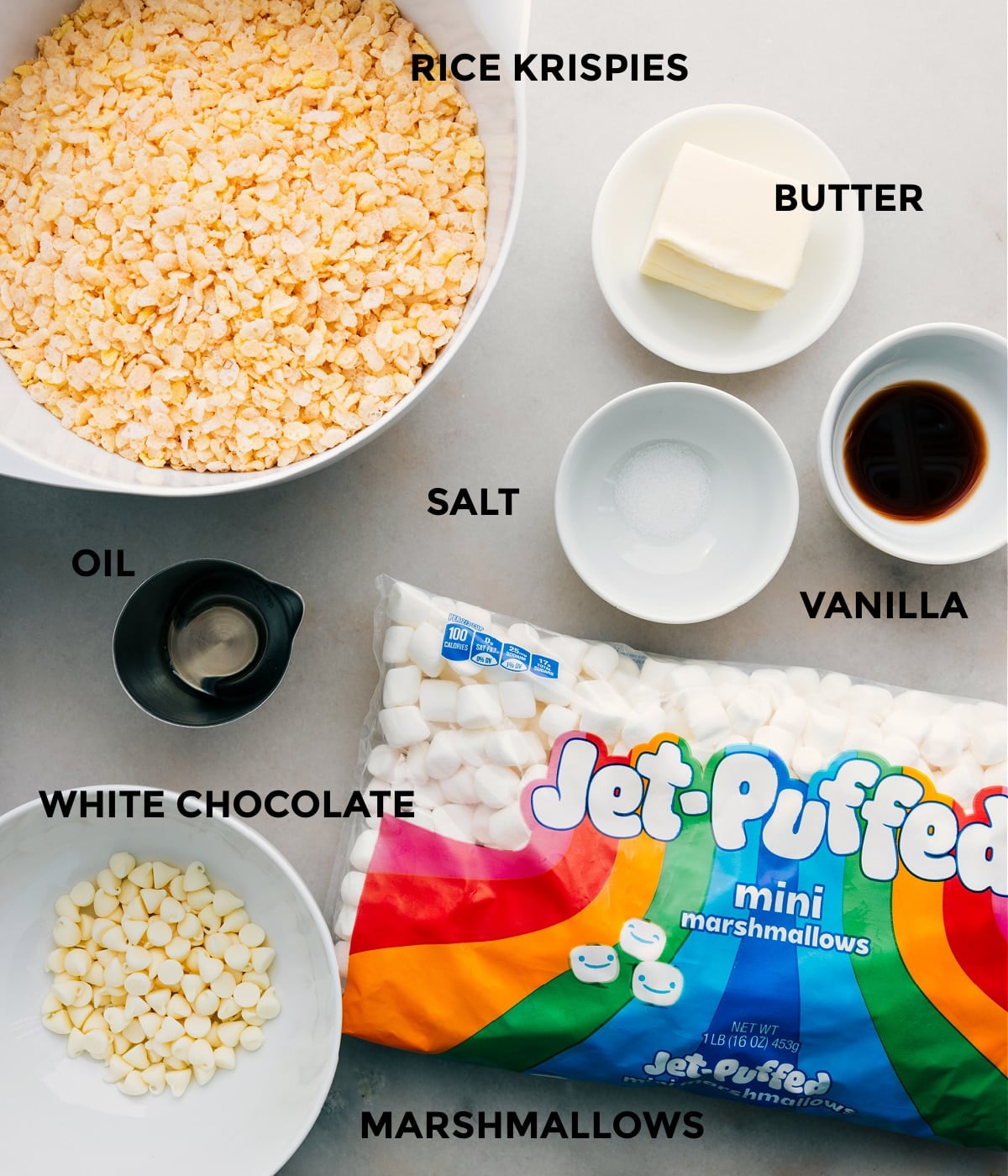 Ingredients In The Best Rice Krispie Treats All the ingredients including cereal, butter, vanilla, salt, oil, white chocolate, and marshmallows in this recipe prepped out for easy assembly.
