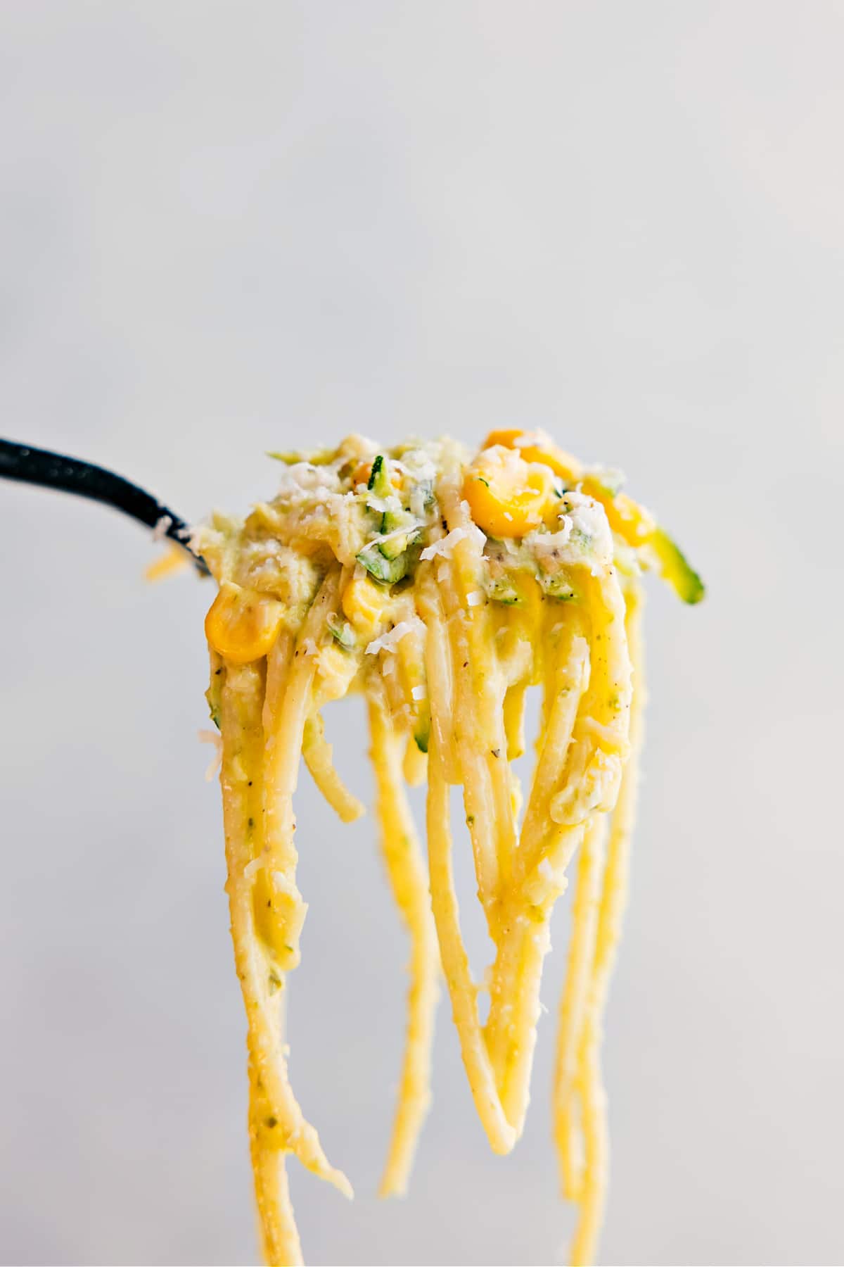 You Won't Be Able To Get Enough Of This Zucchini Pasta Sauce A forkful of the pasta being held up showing all the yummy components to it.