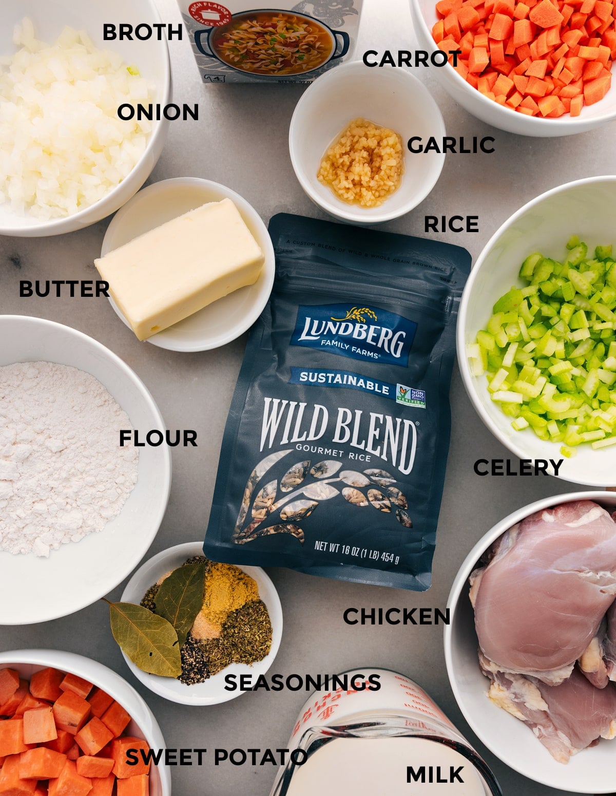 Ingredients In Crockpot Chicken And Wild Rice Soup Prep all the ingredients for this recipe, including meat, seasonings, veggies, flour, butter, milk, rice blend, and broth, for easy assembly.