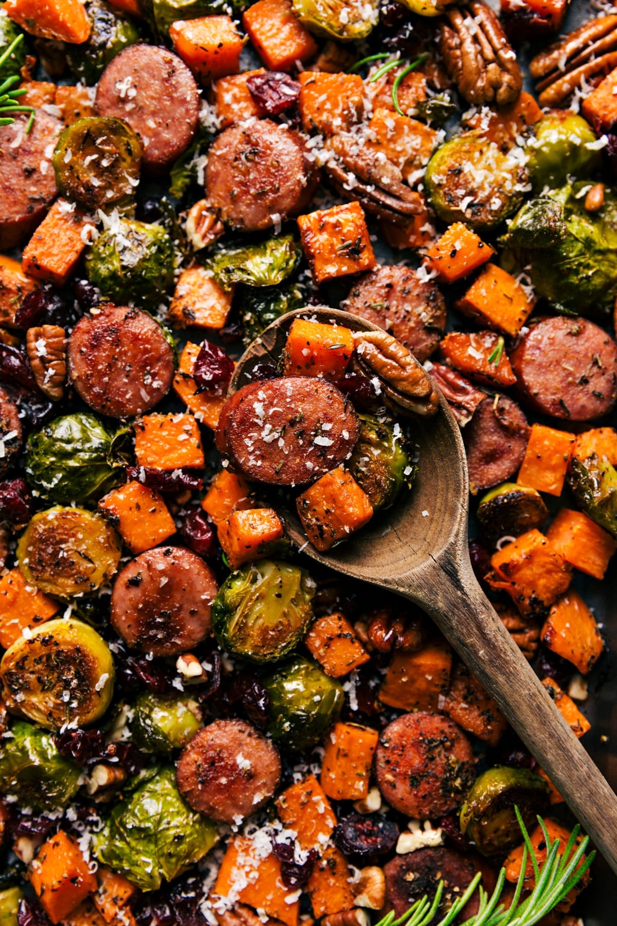 Roasted harvest vegetables and sausage on a sheet pan.