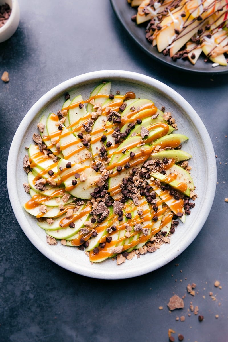 Easy to make, impressive to look at, and super delicious and kid friendly! You're going to love these apple nachos! Recipe via ChelseasMessyApron.com #apples #nachos #applenachos #afterschool #snack #fruit Overhead image of the heath Apple Nachos version