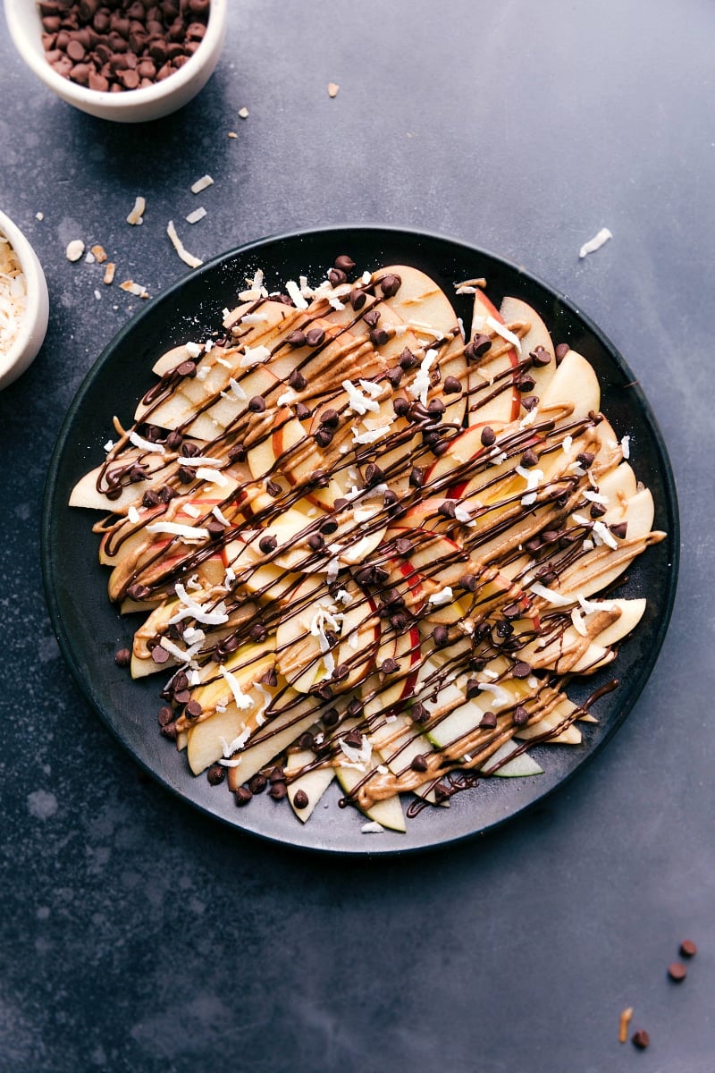 Apple Nachos are the best after-school snack ever! Easy to make, impressive to look at, and super delicious and kid friendly! Recipe vis ChelseasMessyApron.com #apples #nachos #applenachos #afterschool #snack #fruit Overhead image of the chocolate version of this treat