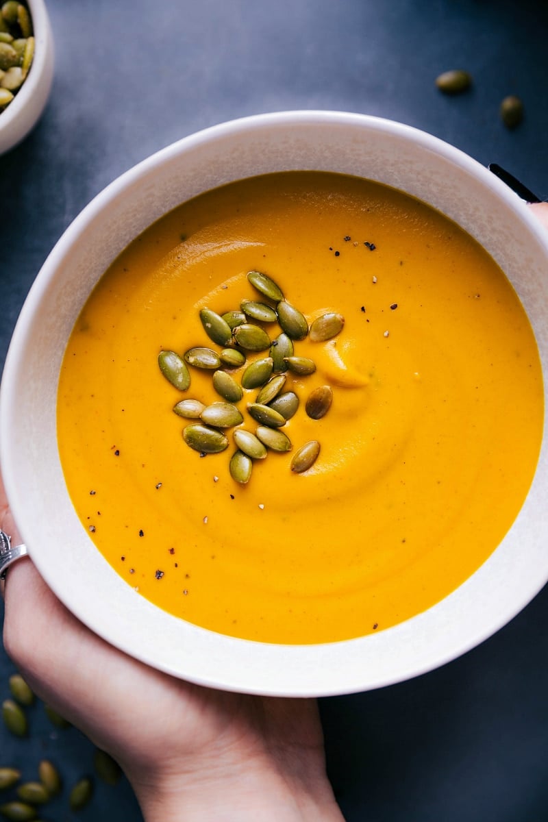 Creamy Sweet Potato Soup Recipe in a bowl, sprinkled with crunchy pepitas, ready to be enjoyed.