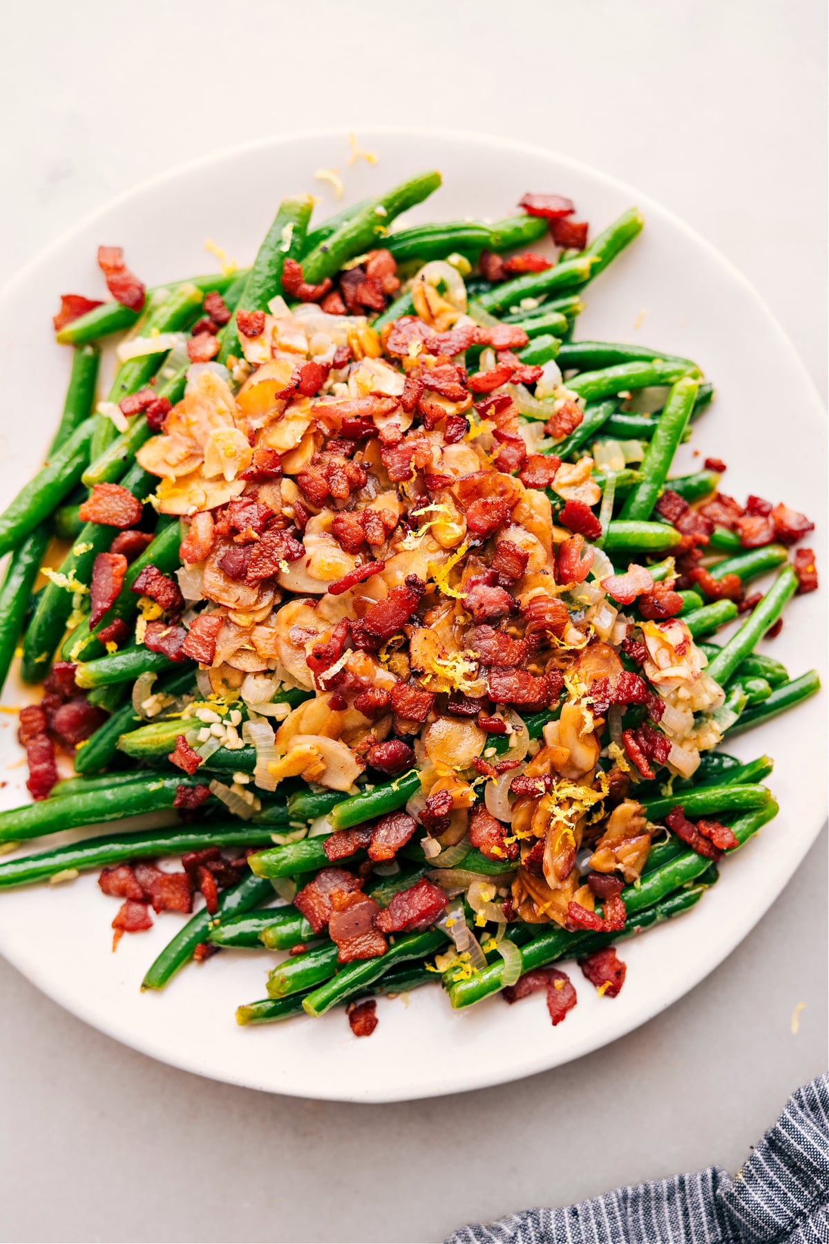 The Best Green Beans With Bacon Recipe Green Beans with Bacon, topped with fresh lemon juice and zest, make a delicious side.