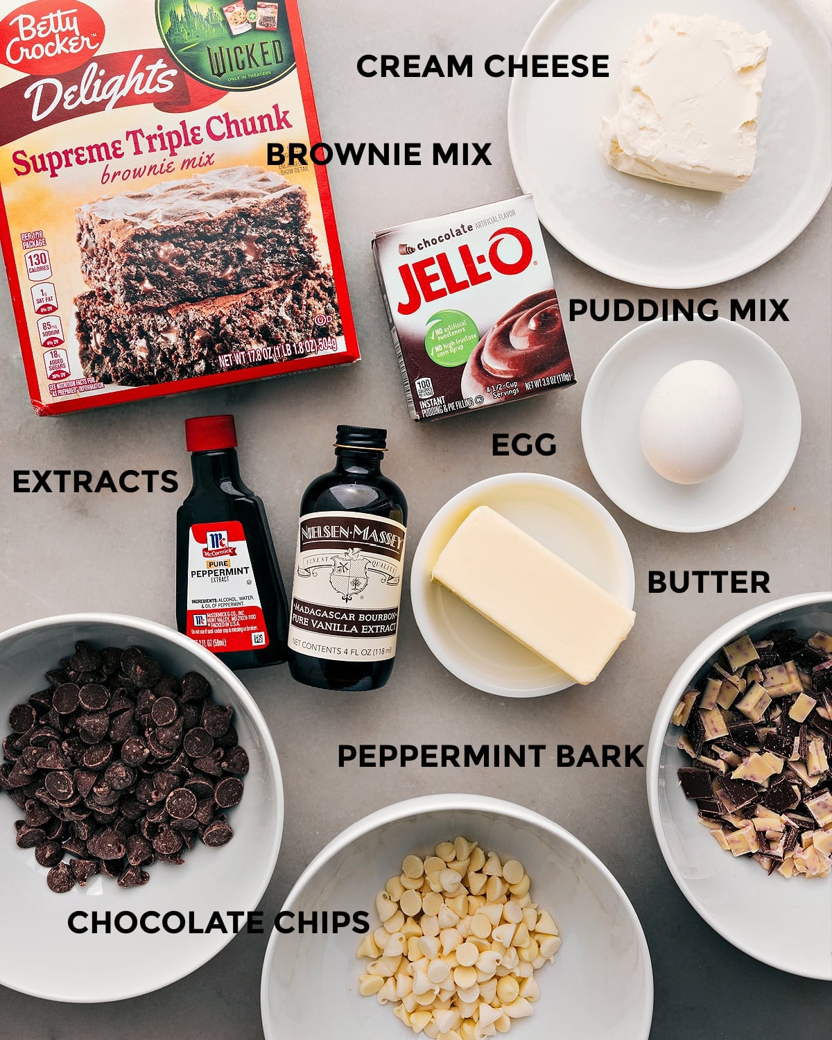 Prepping Wet and Dry Ingredients for Delicious Batter Creation The ingredients for this recipeโbrownie mix, pudding mix, cream cheese, egg, butter, extracts, and chocolate chipsโare prepped and ready for easy assembly.