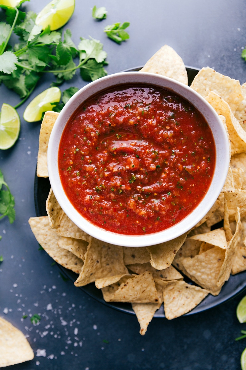 Flavorful Salsa with Chips A big bowl of delicious salsa, packed with vibrant flavors, paired with a pile of crispy chips ready for dipping.