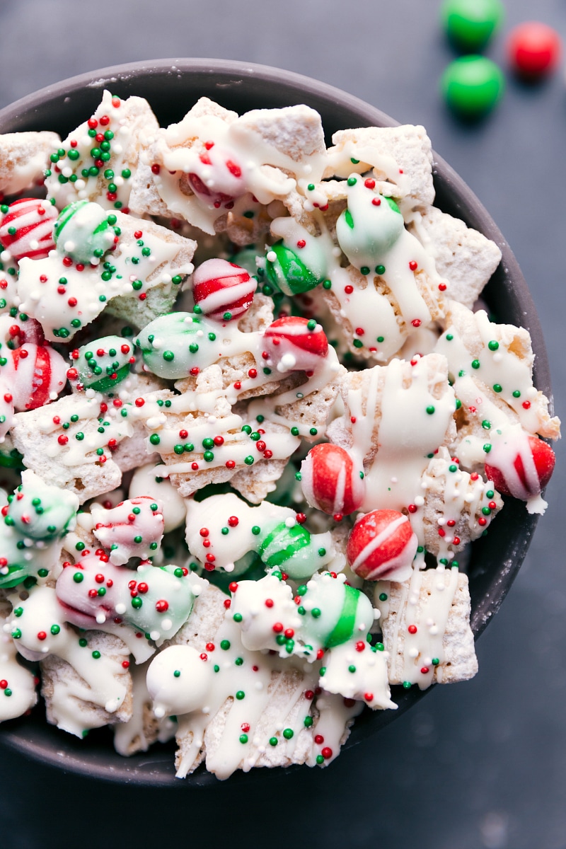 This fun Sugar Cookie Snack Mix channels the flavors of a Christmas cookie into an addicting, crunchy, sweet snack mix. We're obsessed with this treat! Recipe via chelseasmessyapron #recipe #quick #easy #christmas #holiday #m&ms #delicious #best #sugarcookie #snack #mix View of Christmas Cookie Snack Mix in a bowl.