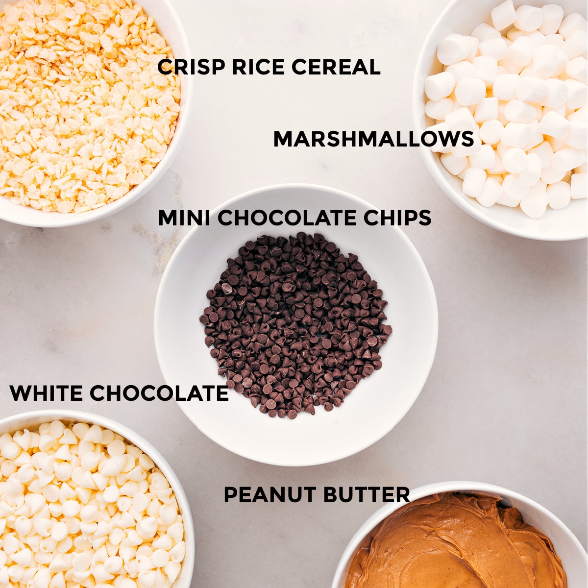Ingredients In Avalanche Cookies Recipe All the ingredients for this recipe are prepped and ready for easy assembly: marshmallows, chocolate chips, white chocolate, peanut butter, and Rice Krispie cereal.