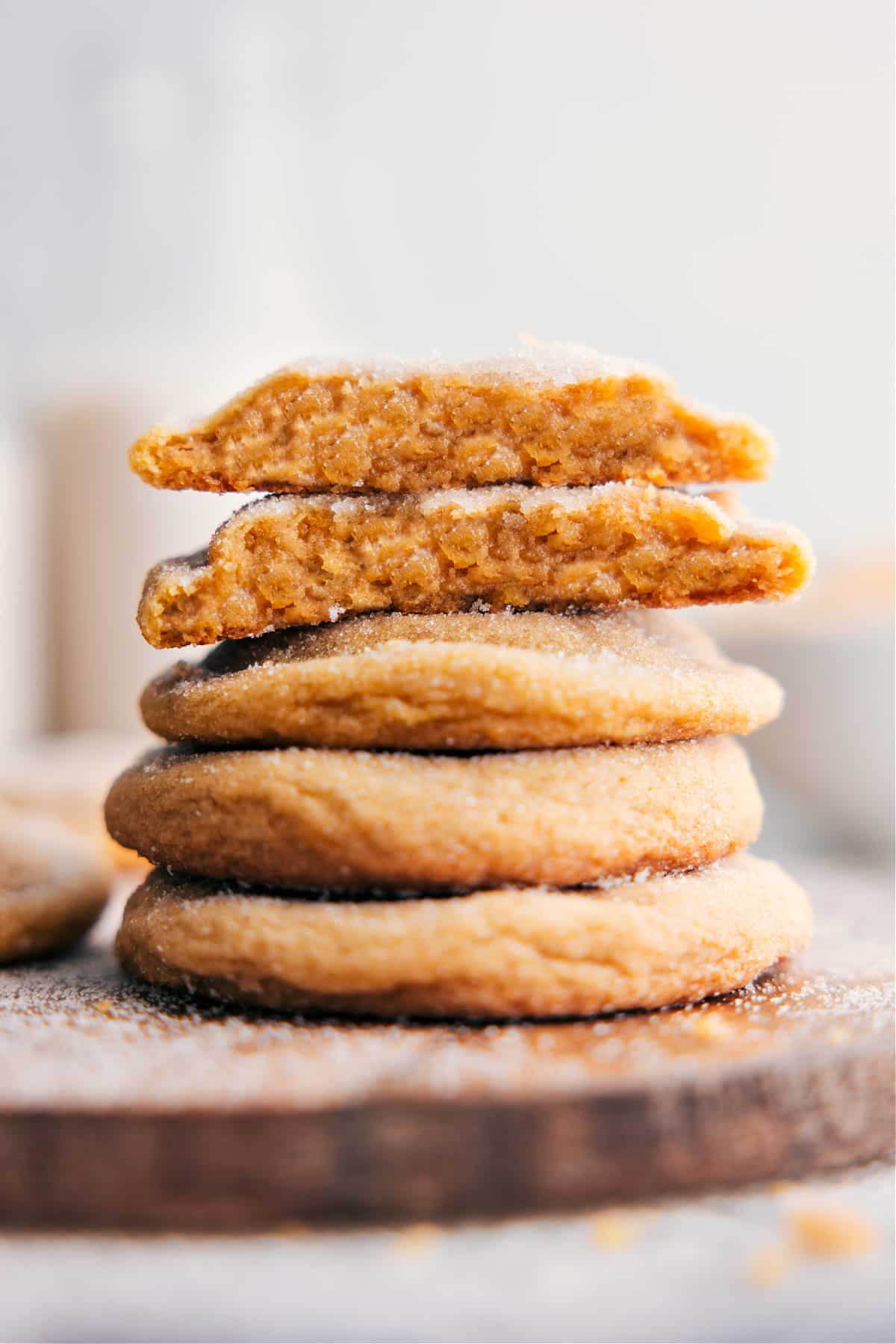 The Best Brown Sugar Cookie Recipe Brown Sugar Cookies stacked on top of each other, with one broken in half to reveal the delicious inside.