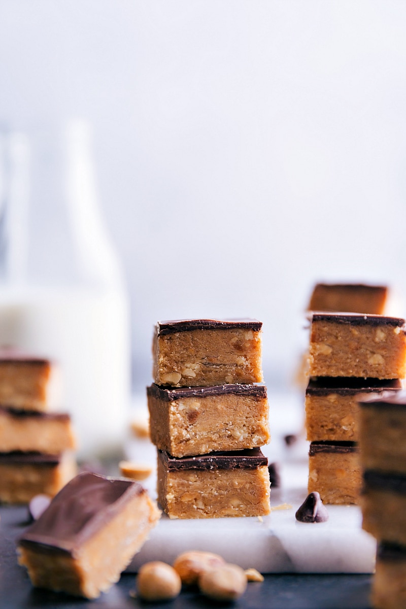 Homemade peanut butter and chocolate Buttercrunch Candy! Recipe via chelseasmessyapron.com #candy #buttercrunch #peanut #chocolate #holiday #easy Image of a stack of Buttercrunch Candy squares.