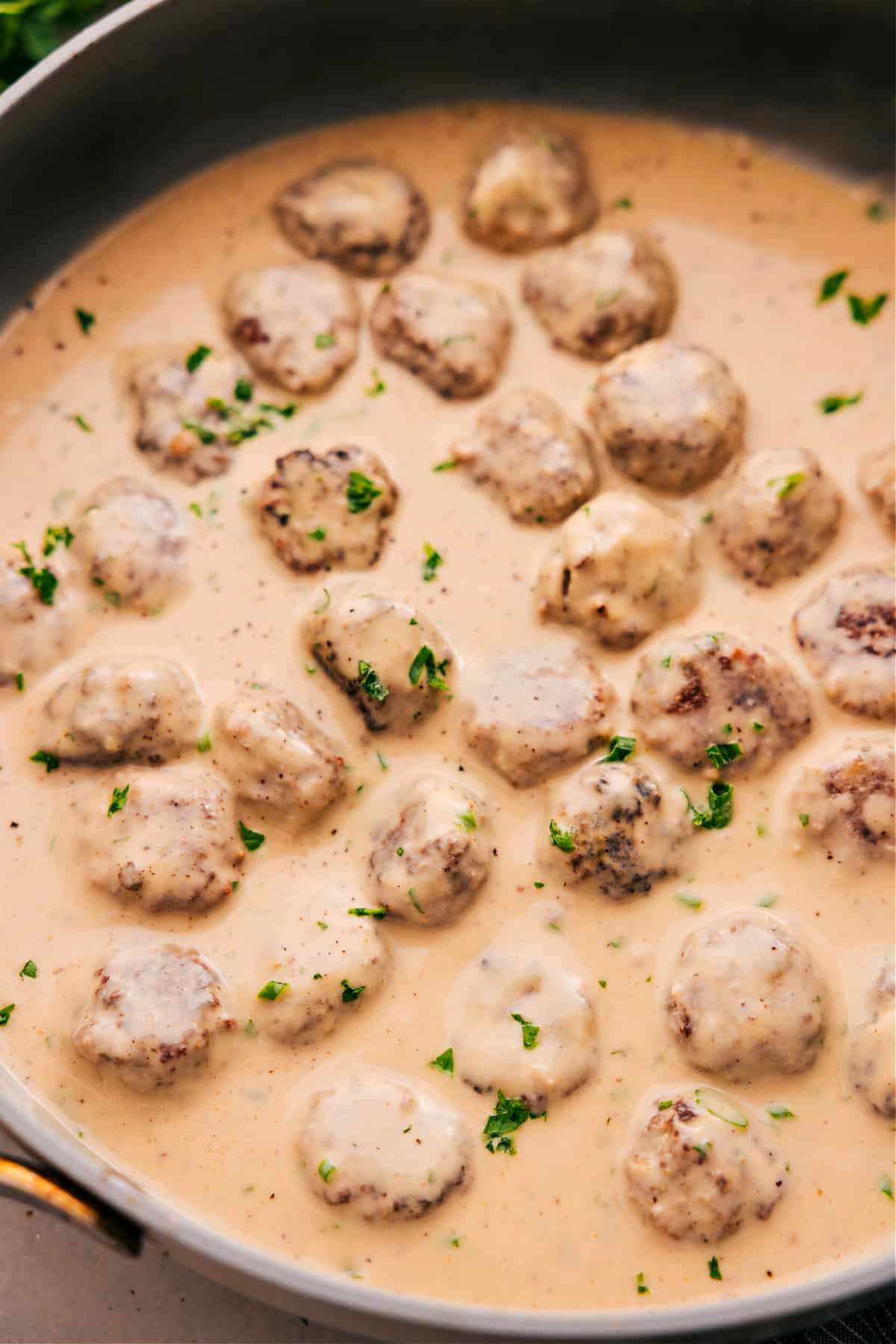 Swedish Meatballs Made In One Skillet Swedish meatballs in cream sauce, topped with freshly chopped parsley, ready to serve and enjoy.
