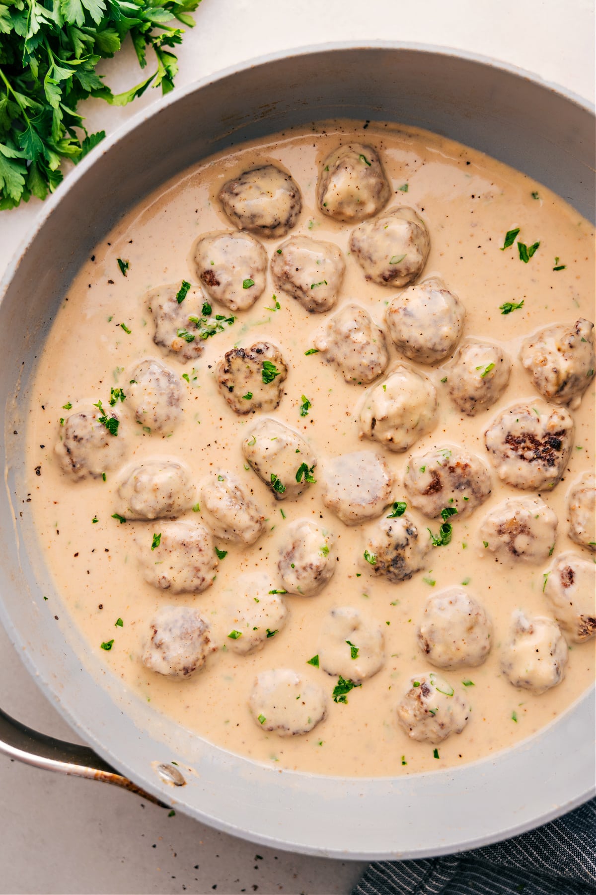The Best Swedish Meatballs Recipe Swedish Meatballs simmering in cream sauce.