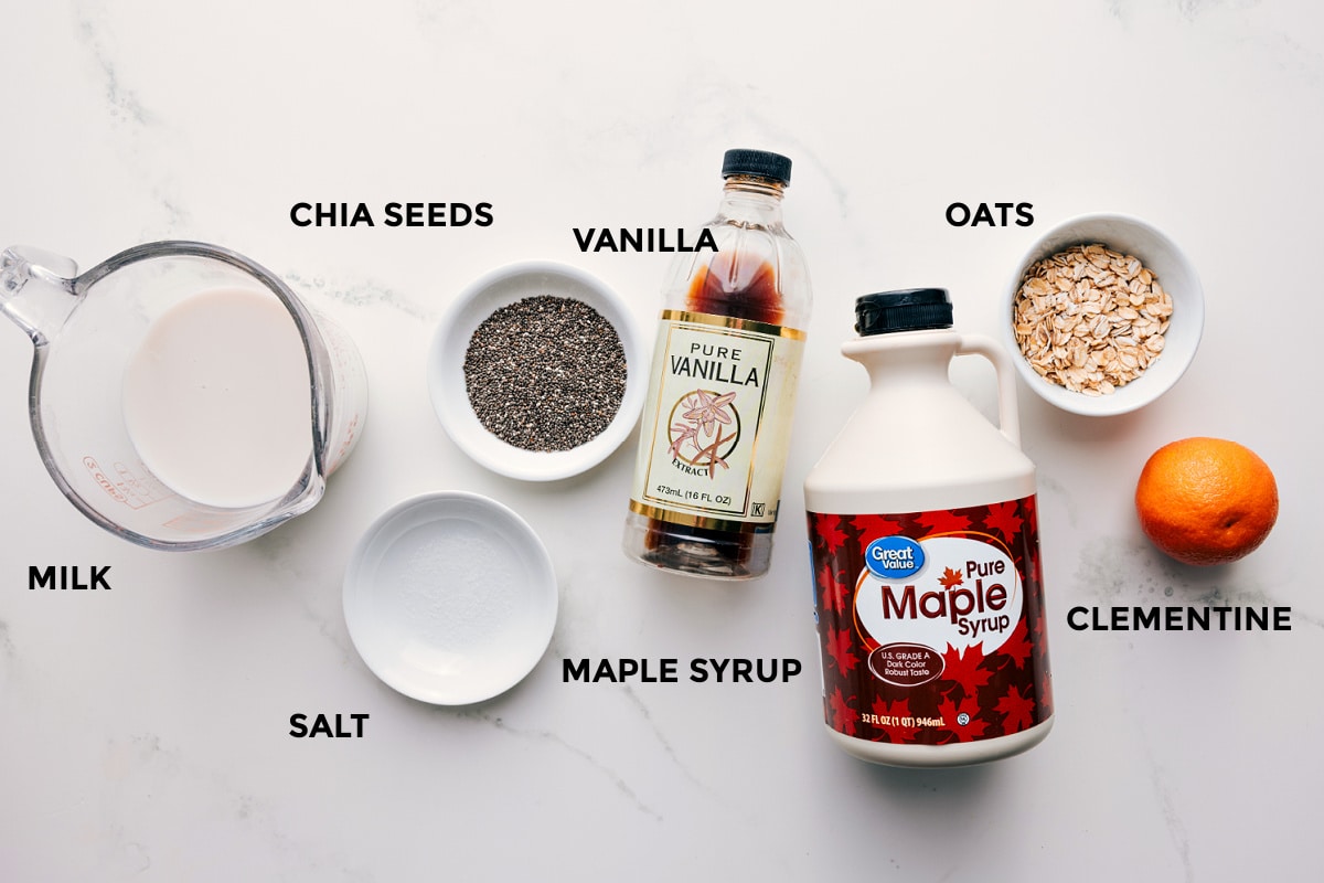 Ingredients In Chia Pudding Recipe All the ingredients in this recipe prepped out for easy assembly including the milk, chia seeds, salt, maple syrup, vanilla, oats, and clementine.