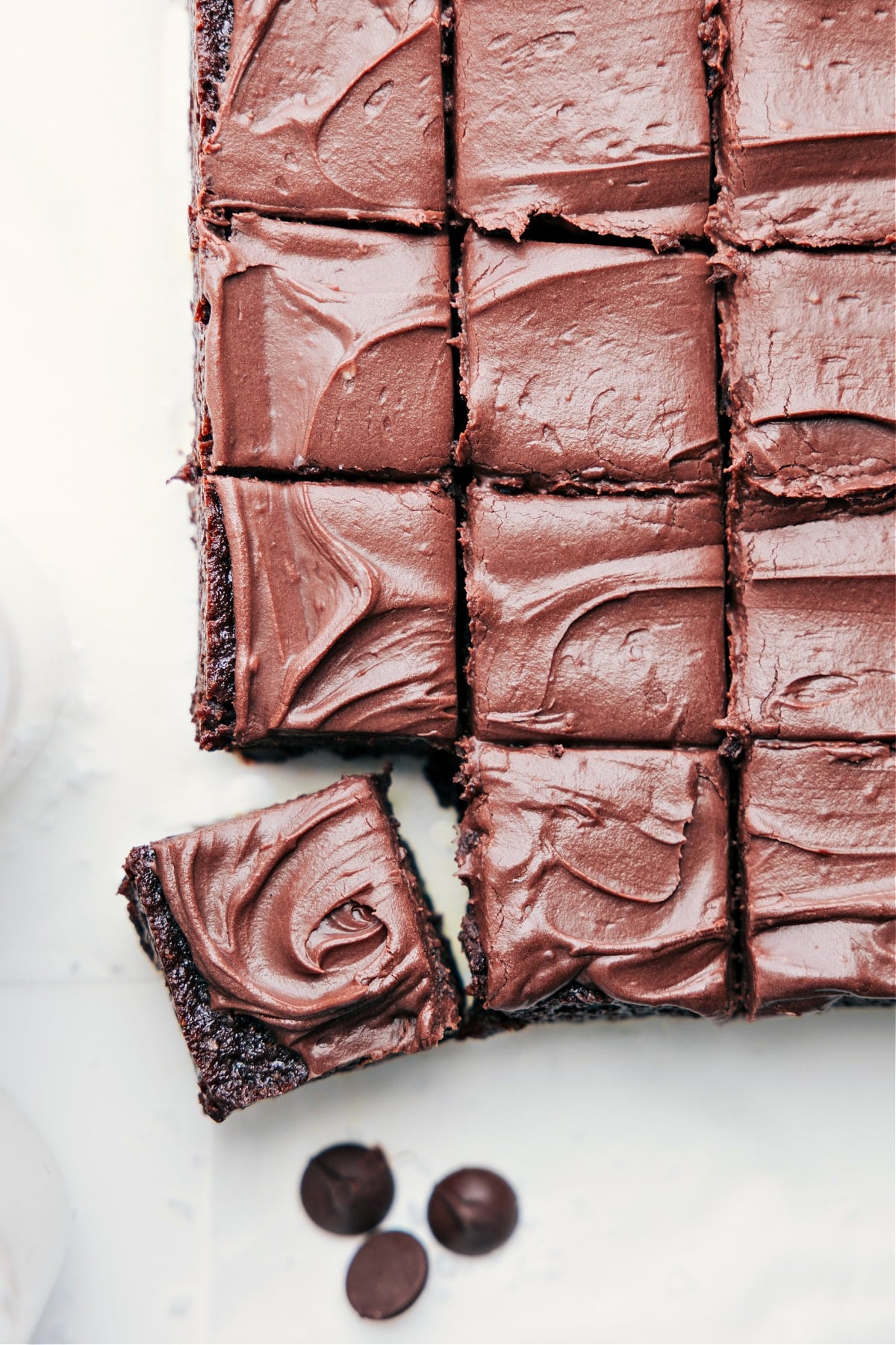 Healthy Brownies sliced with rich chocolate frosting on top.