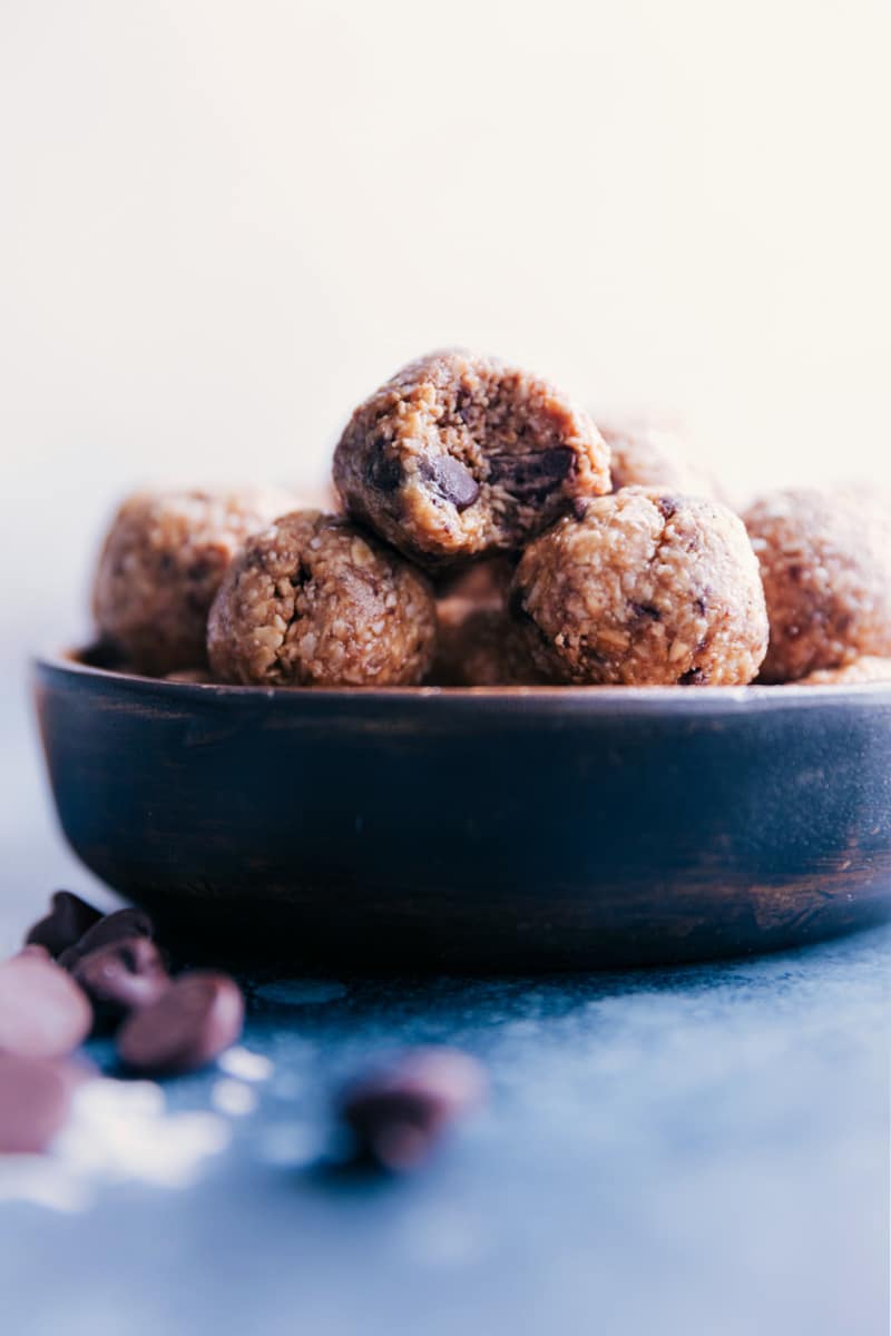 These delicious pop-able bites taste like healthy oatmeal chocolate chip cookies! Recipe via ChelseasMessyApron.com #oatmeal #energyballs #healthy #peanutbutter #honey #coconut View of a bowl of Oatmeal Energy Balls.