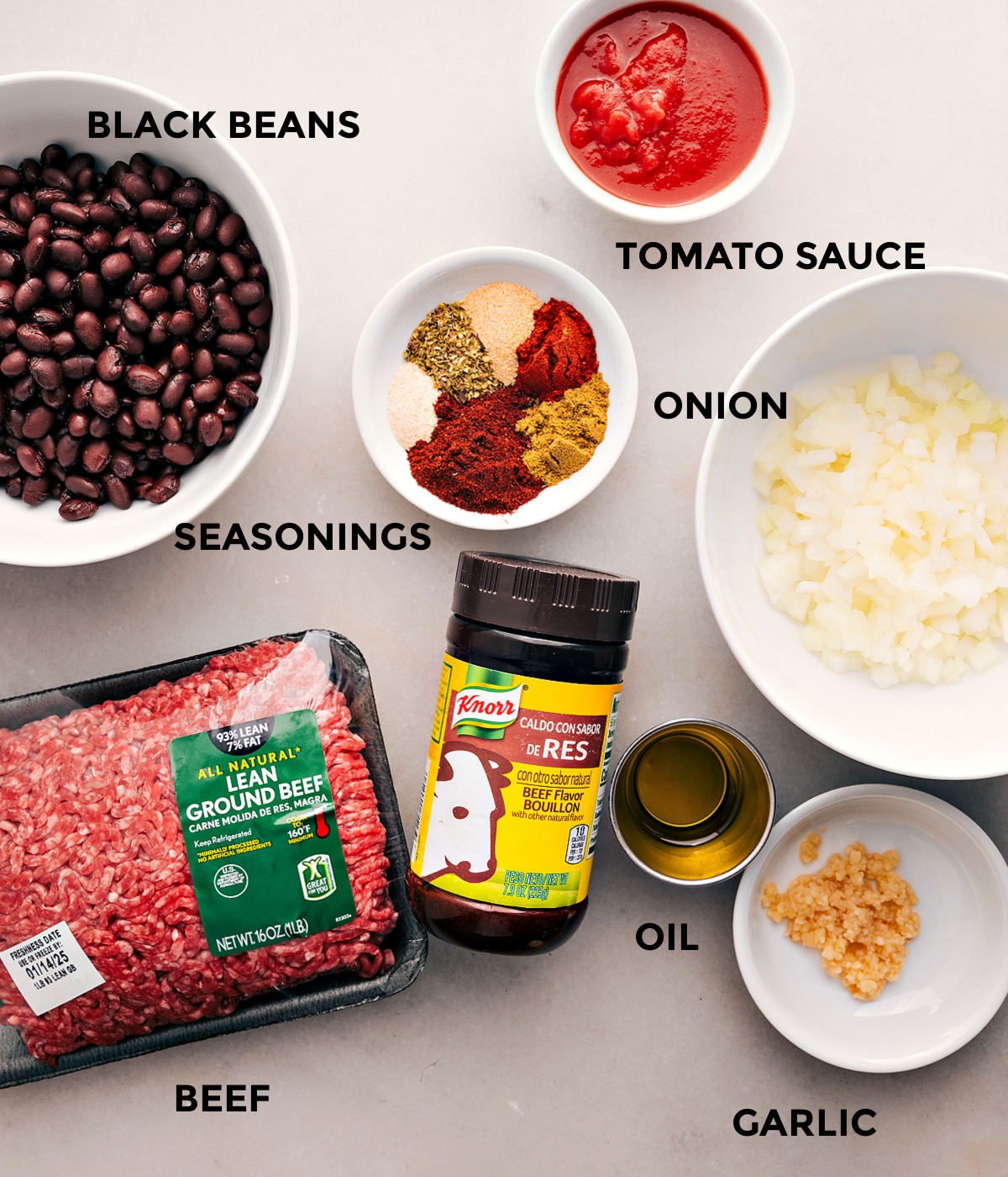 Ingredients In Taco Stuffed Sweet Potatoes All the ingredients for this recipe are prepped and ready for easy assembly, including tomato sauce, beef, onion, black beans, seasonings, oil, and garlic.