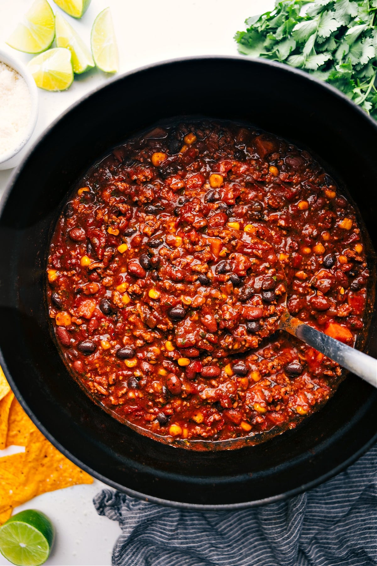 Turkey Chili Recipe in a pot with a large ladle scooping out a hearty serving of chili.