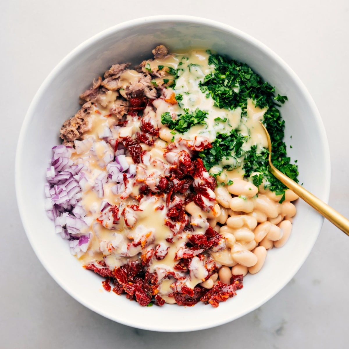 Easy And Delicious Tuna White Bean Salad The dressed dish ready to be tossed together and enjoyed.