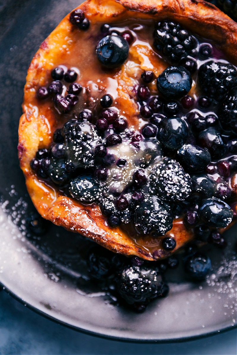 Top your Dutch Baby with your favorites -- we love fresh berries and a quick vanilla sauce. Recipe via chelseasmessyapron #breakfast #quick #easy #simple #delicious #best #berries #airfryer #dutchbaby Overhead view of an Air Fryer Dutch Baby.