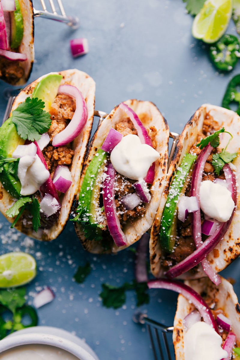 Ground Pork Tacos! Recipe via chelseasmessyapron #dinner #quick #easy #simple #best #redonion #crema #avocado #limes #groundpork #tacos Three Ground Pork Tacos