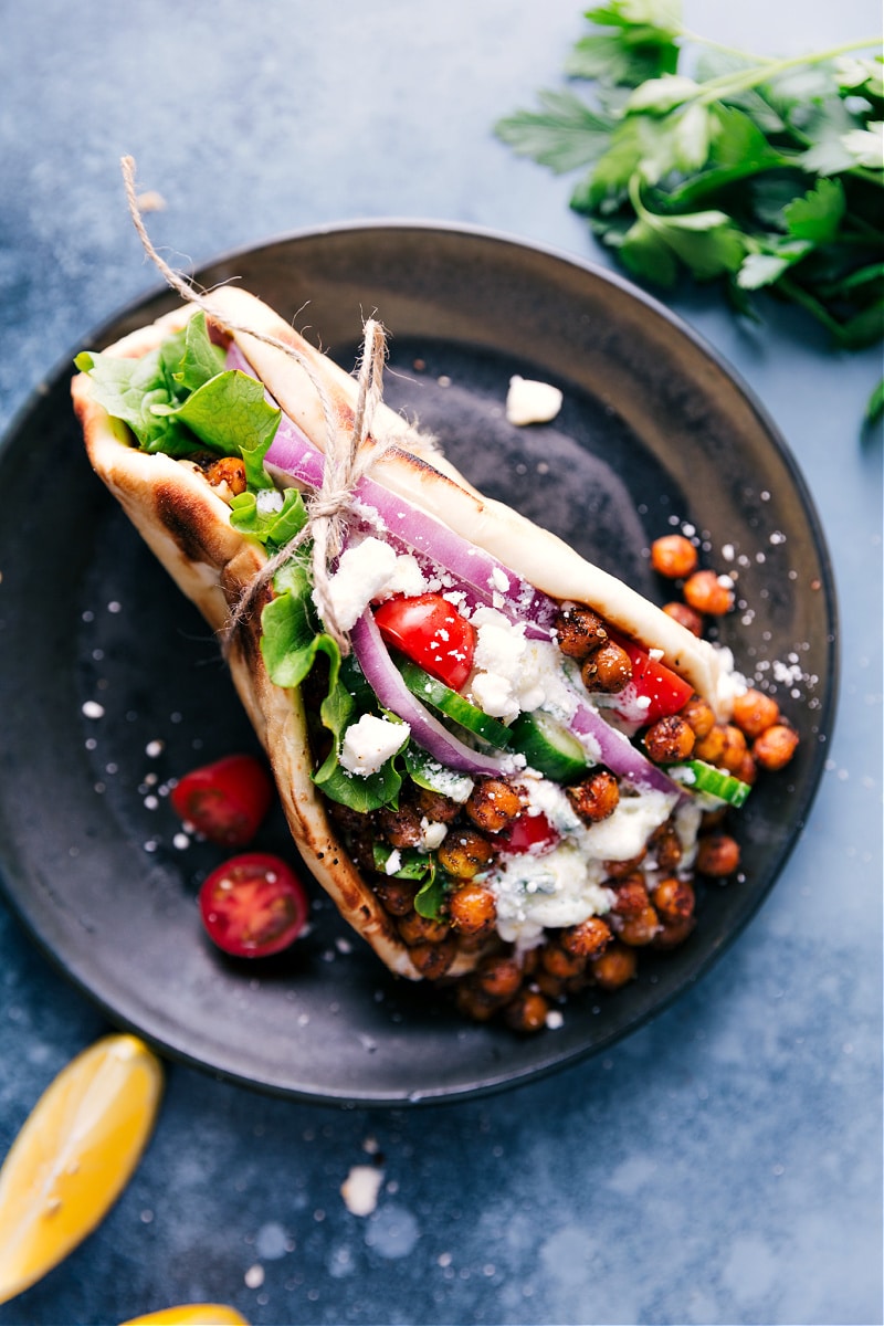 This easy, weeknight meal can be ready in about 30 minutes or less if you’ve got an air fryer! #dinner #healthy #whole #whole30 #best #quick #easy #simple #greek #vegetarian #gyros Overhead view of a filled pita bread for Vegetarian Gyros.