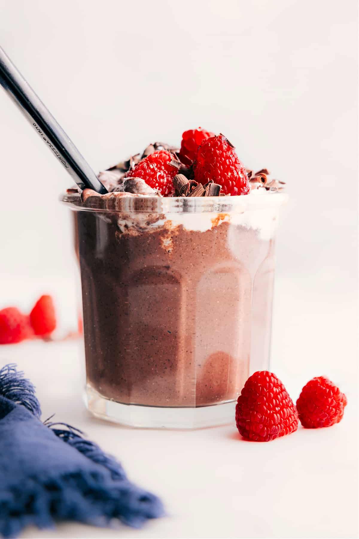Chocolate Chia Seed Pudding in a mason jar topped with whipped cream and fresh berries.